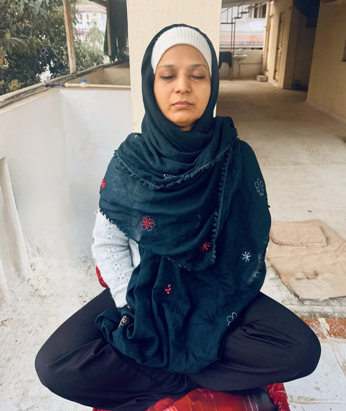 A woman seated in meditation outdoors